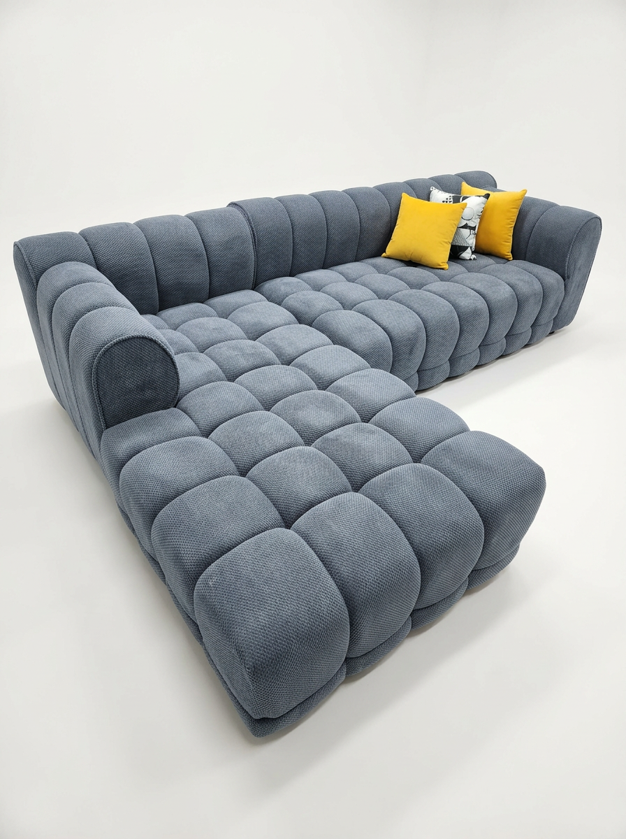Slate blue bubble tufted L-shape sectional with yellow pillows