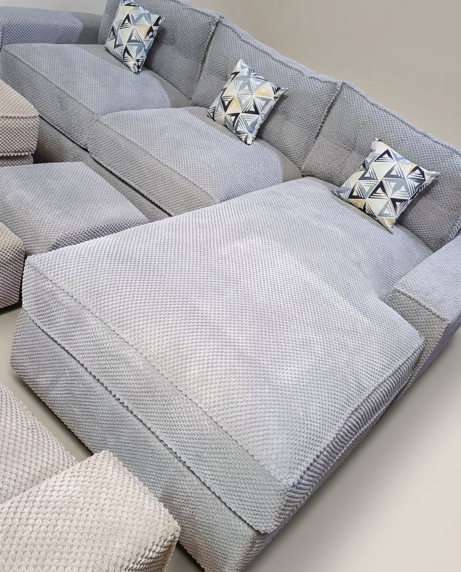 Light grey textured weave modular sectional with triangle pillows