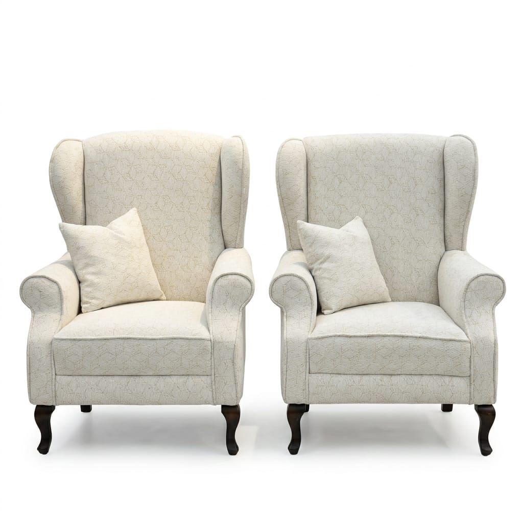 Pair of cream embossed wingback armchairs with cabriole legs