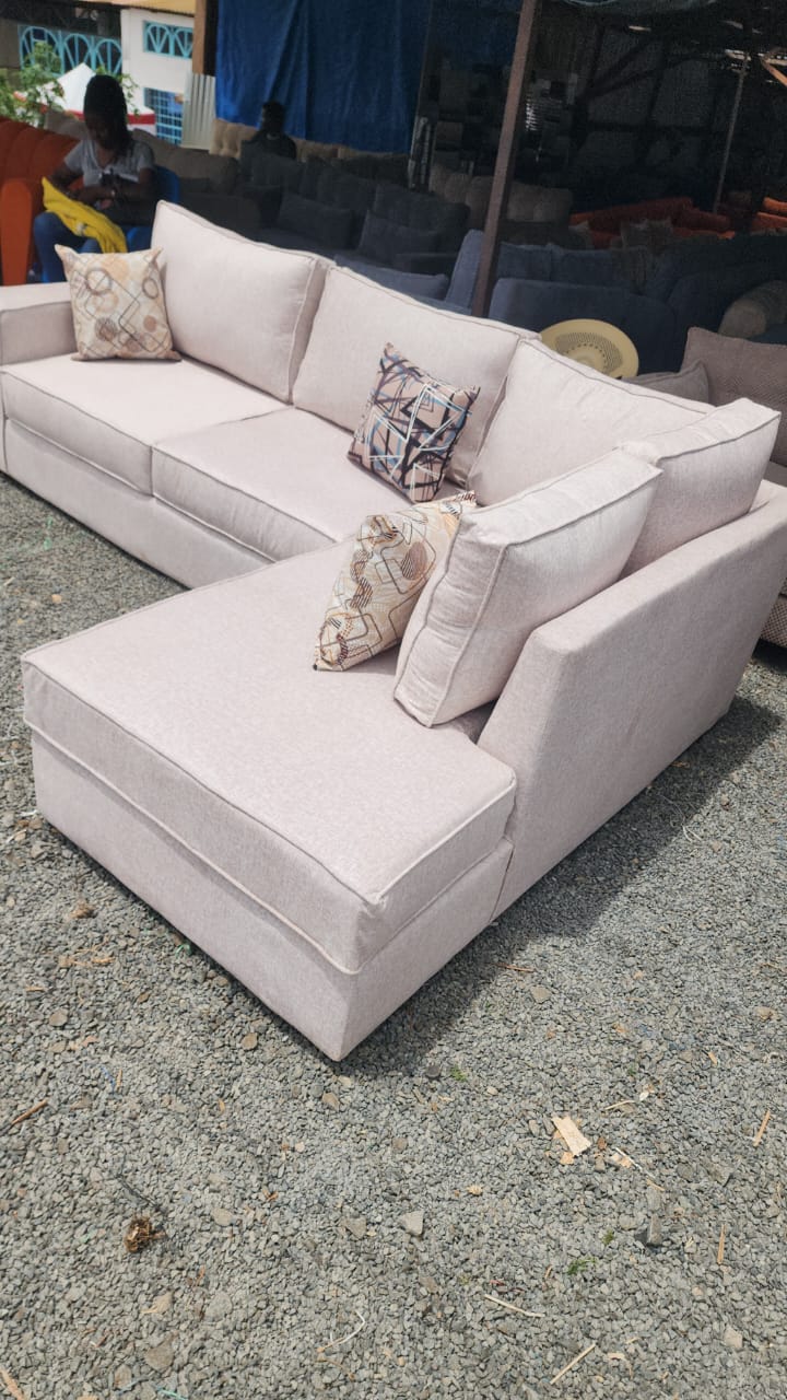 Blush cream L-shape sofa with deep chaise and patterned scatter cushions